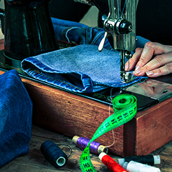 Sewing machine being used for clothing repairs and alterations